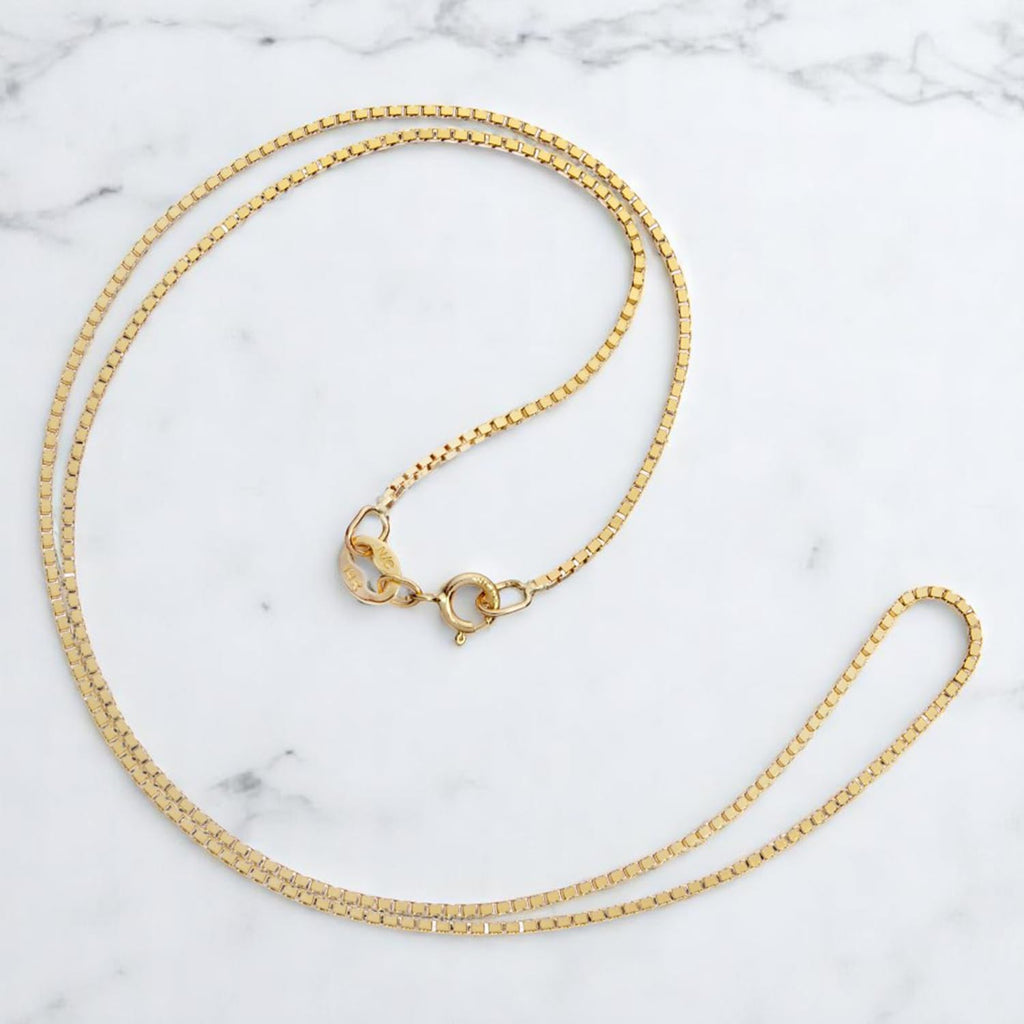 everyday elegance 10k gold box chain necklace for on a desk or shelf